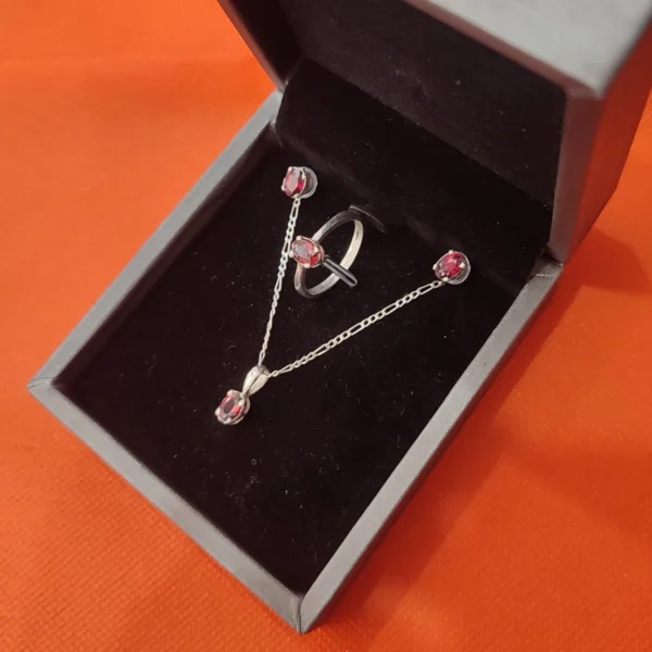 Handmade silver jewelry set with natural garnet gemstones including ring, pendant, and earrings.