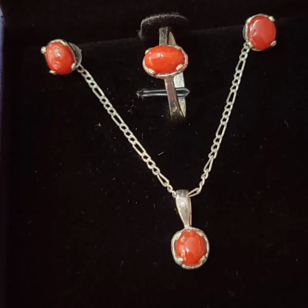 Close-up of Marjan red coral stones in a handmade silver jewellery set