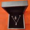 Red garnet handcrafted jewelry set made of silver with matching ring, pendant, and earrings.